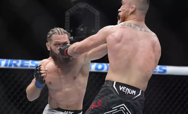 Justin Gaethje, right, and Rafael Fiziev exchange blows during a UFC 313 mixed martial arts lightweight bout Saturday, March 8, 2025, in Las Vegas. (AP Photo/John Locher)