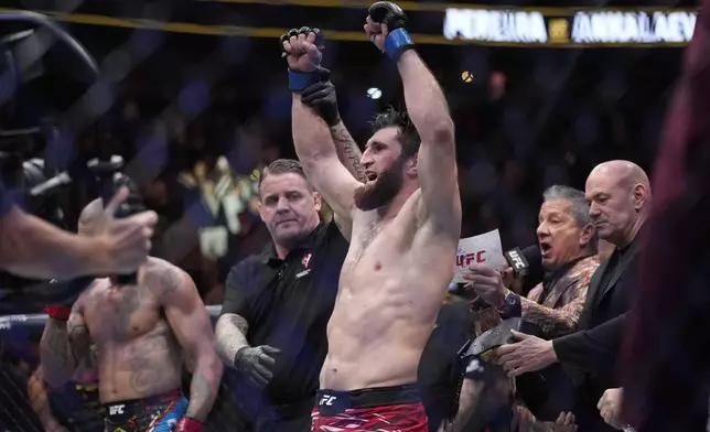 Magomed Ankalaev celebrates after defeating Alex Pereira in a UFC 313 mixed martial arts light heavyweight title bout Saturday, March 8, 2025, in Las Vegas. (AP Photo/John Locher)