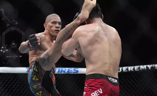 Alex Pereira kicks Magomed Ankalaev during a UFC 313 mixed martial arts light heavyweight title bout Saturday, March 8, 2025, in Las Vegas. (AP Photo/John Locher)