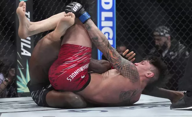 Ignacio Bahamondes, right, fights Jalin Turner during a UFC 313 mixed martial arts lightweight bout Saturday, March 8, 2025, in Las Vegas. (AP Photo/John Locher)