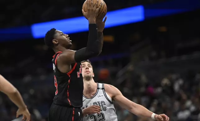 Toronto Raptors guard RJ Barrett (9) goes up to shoot as Orlando Magic forward Franz Wagner (22) defends during the first half of an NBA basketball game, Tuesday, March 4, 2025, in Orlando, Fla. (AP Photo/Phelan M. Ebenhack)