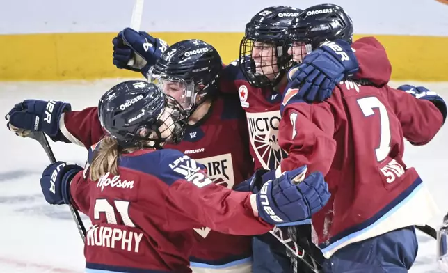 Montreal Victoire's Laura Stacey (7) celebrates with teammates after scoring the winning goal against the Boston Fleet during overtime in a PWHL hockey game in Montreal, Saturday, March 1, 2025. (Graham Hughes/The Canadian Press via AP