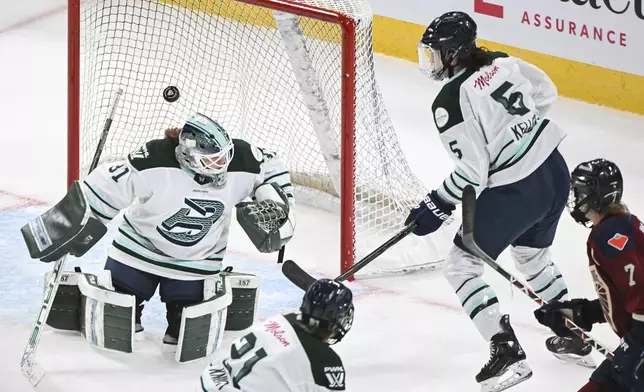 Montreal Victoire's Laura Stacey (7) moves in to score on Boston Fleet goaltender Aerin Frankel (31) as Fleet's Megan Keller (5) defends during overtime in a PWHL hockey game in Montreal, Saturday, March 1, 2025. (Graham Hughes/The Canadian Press via AP