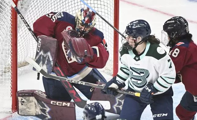 Boston Fleet's Sidney Morin (7) tips the puck past Montreal Victoire goaltender Ann-Renee Desbiens during second period PWHL hockey action in Montreal, Saturday, March 1, 2025. (Graham Hughes/The Canadian Press via AP)