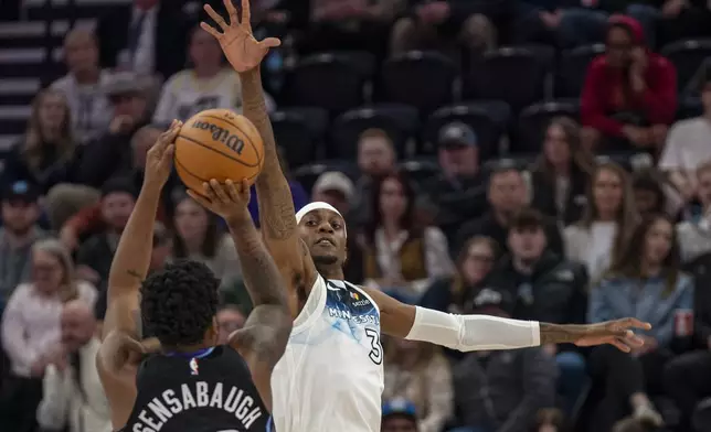 Utah Jazz forward Brice Sensabaugh, left, shoots as Minnesota Timberwolves forward Jaden McDaniels (3) defends, during the first half of an NBA basketball game Friday, Feb. 28, 2025, in Salt Lake City. (AP Photo/Rick Egan)