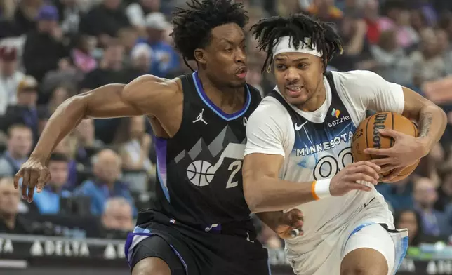 Minnesota Timberwolves guard Terrence Shannon Jr., right, takes the ball to the hoop as Utah Jazz guard Collin Sexton (2) defends during the first half of an NBA basketball game Friday, Feb. 28, 2025, in Salt Lake City. (AP Photo/Rick Egan)
