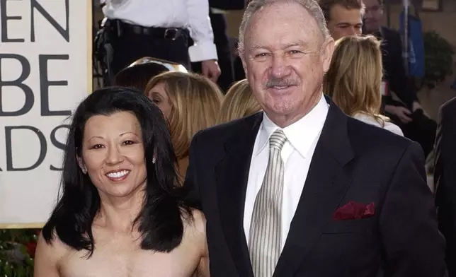 FILE - Actor Gene Hackman arrives with his wife, Betsy Arakawa, for the 60th Annual Golden Globe Awards in Beverly Hills, Calif., Sunday, Jan. 19, 2003. (AP Photo/Mark J. Terrill, File)