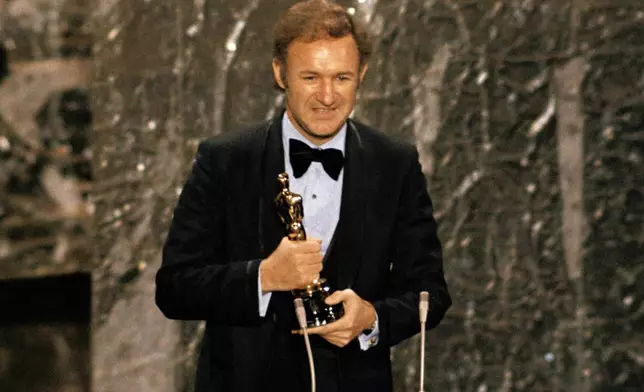 FILE - Gene Hackman accepts his Oscar for best actor at the 44th Academy Awards in Los Angeles on April 10, 1972. (AP Photo, File)