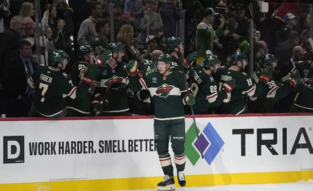 Minnesota Wild left wing Matt Boldy (12) celebrates with teammates after scoring a goal during the second period of an NHL hockey game against the Washington Capitals, Thursday, March 27, 2025, in St. Paul, Minn. (AP Photo/Abbie Parr)