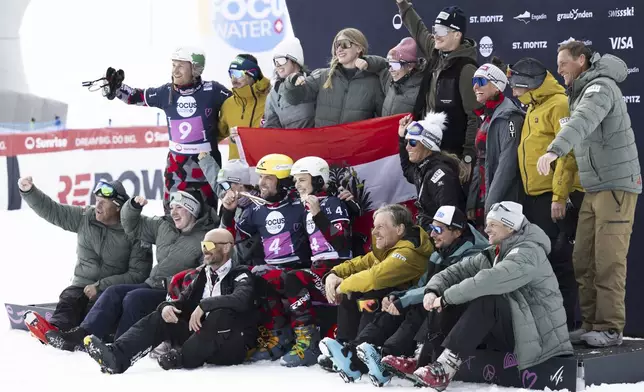 Bronze medalists Andreas Prommegger of Austria and Sabine Payer of Austria and team pose on the podium at the Snowboard Alpine Parallel-Slalom competition at the FIS Snowboard, Freestyle and Freeski World Championships, Sunday, March 23, 2025, in St. Moritz, Switzerland. (Gian Ehrenzeller/Keystone via AP)