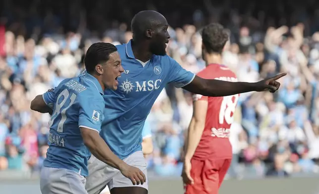 Napoli's Romelu Lukaku, right, celebrates scoring with Giacomo Raspadori during the Serie A soccer match between Napoli and Fiorentina at the Diego Armando Maradona Stadium in Naples, Italy, Sunday March 9, 2025. (Alessandro Garofalo/LaPresse via AP)