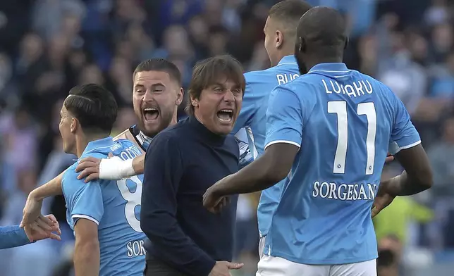 Napoli's head coach Antonio Conte, center, celebrates after Giacomo Raspadori, left, scores during the Serie A soccer match between Napoli and Fiorentina at the Diego Armando Maradona Stadium in Naples, Italy, Sunday March 9, 2025. (Alessandro Garofalo/LaPresse via AP)