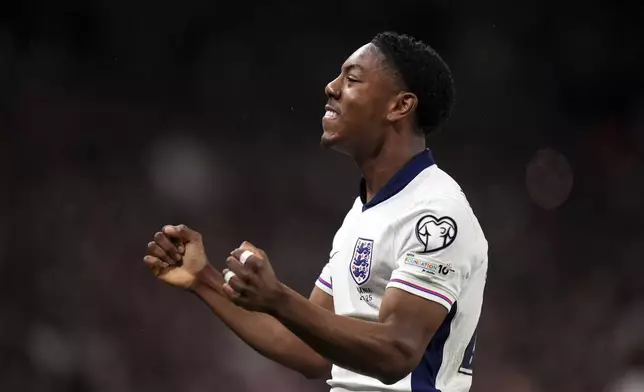 England's Myles Lewis-Skelly celebrates scoring his side's first goal during the World Cup qualifying soccer match between England and Albania at Wembley stadium in London, Friday, March 21, 2025. (Bradley Collyer/PA via AP)