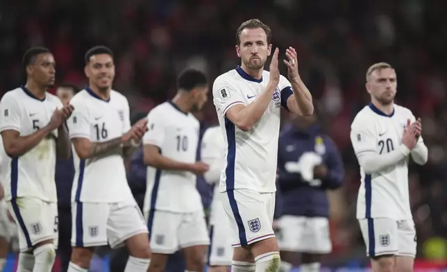 England's Harry Kane and his teammates applaud to fans at the end of a World Cup qualifying soccer match between England and Albania at Wembley stadium in London, Friday, March 21, 2025. (AP Photo/Alastair Grant)