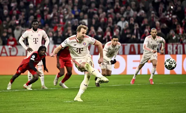 Munich's Harry Kane scores his side's third goal during the Champions League round of 16 first leg soccer match between FC Bayern Munich and Bayer 04 Leverkusen in Munich, Germany, Wednesday, March 5, 2025. (Tom Weller/dpa via AP)