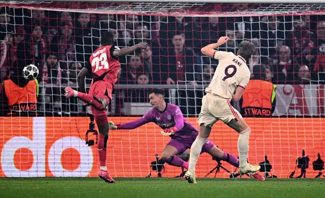 Munich's Harry Kane, right, scores the opening goal during the Champions League round of 16 first leg soccer match between FC Bayern Munich and Bayer 04 Leverkusen in Munich, Germany, Wednesday, March 5, 2025. (Tom Weller/dpa via AP)