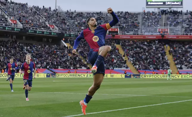 Barcelona's Ronald Araujo celebrates scoring his side's 3rd goal during the Spanish La Liga soccer match between Barcelona and Real Sociedad at the Lluis Companys Olympic Stadium in Barcelona, Spain, Sunday, March 2, 2025. (AP Photo/Joan Monfort)