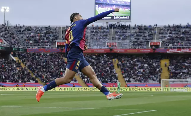 Barcelona's Ronald Araujo celebrates scoring his side's 3rd goal during the Spanish La Liga soccer match between Barcelona and Real Sociedad at the Lluis Companys Olympic Stadium in Barcelona, Spain, Sunday, March 2, 2025. (AP Photo/Joan Monfort)
