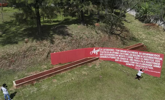The sun shines down on a mass grave at the Dom Bosco cemetery, where victims of Brazil's military dictatorship (1964-1985) were buried clandestinely, during a government ceremony to officially apologize to victims' families, in Sao Paulo, Monday, March 24, 2025. (AP Photo/Andre Penner)