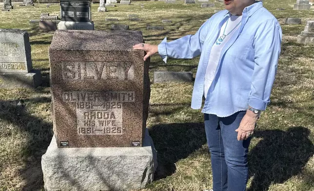 Sylvia Carvell, 81, of Murphybsoro, appears in this March 11, 2025 photo near the grave in Tower Grove Cemetery of her great-grandparents, (AP Photo/John O'Connor)