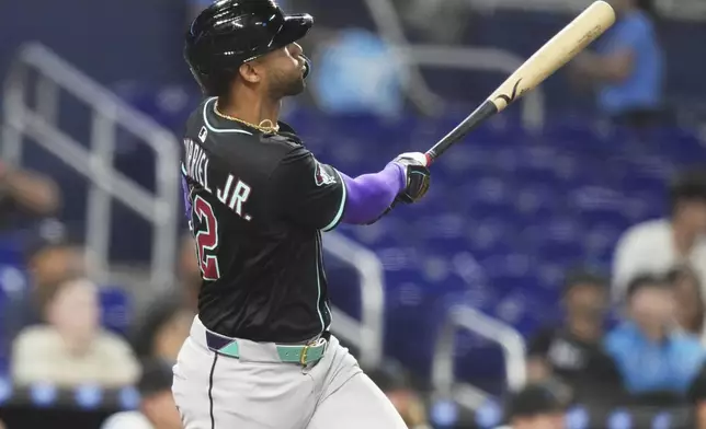 Arizona Diamondbacks' Lourdes Gurriel Jr. watches after hitting a two run home run during the eighth inning of a baseball game against the Miami Marlins, Wednesday, April 16, 2025, in Miami. (AP Photo/Lynne Sladky)