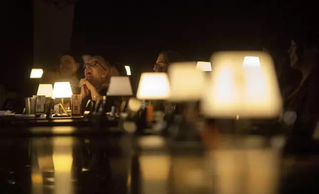 Audience members laugh during Stand Up For Climate, a comedy show at Flappers Comedy on Thursday, March 20, 2025, in Burbank, Calif. (AP Photo/Ethan Swope)
