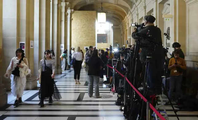 Reporters cover the opening day of the trial of the 2016 armed robbery of Kim Kardashian, at the palace of justice Monday, April 28, 2025 in Paris. (AP Photo/Aurelien Morissard)