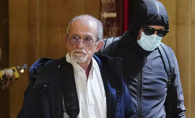 Defendant Aomar Aït Khedache, left, one of the men accused in the 2016 armed robbery of Kim Kardashian, arrives at the palace of justice Monday, April 28, 2025 in Paris. (AP Photo/Aurelien Morissard)