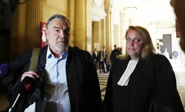 Franck Berton, left, and Chloe Arnaux, lawyers for Aomar Aït Khedache, one of the men accused in the 2016 armed robbery of Kim Kardashian, face reporters at the palace of justice Monday, April 28, 2025 in Paris. (AP Photo/Aurelien Morissard)