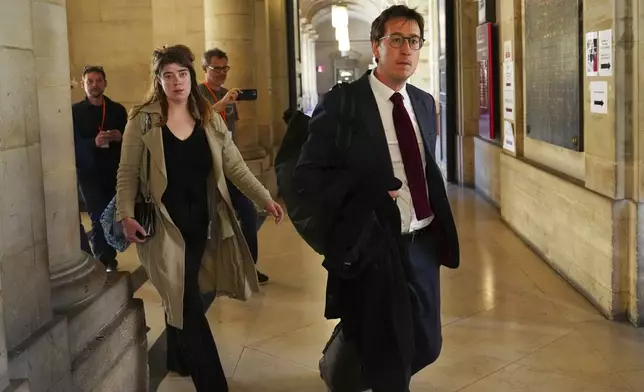 Gabriel Dumenil, right, lawyer of Yunice Abbas, one of the men accused in the 2016 armed robbery of Kim Kardashian, arrives at the palace of justice Monday, April 28, 2025 in Paris. (AP Photo/Aurelien Morissard)