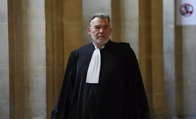 Franck Berton, a lawyer for Aomar Aït Khedache, one of the men accused in the 2016 armed robbery of Kim Kardashian, leaves during a break at the palace of justice Monday, April 28, 2025 in Paris. (AP Photo/Aurelien Morissard)