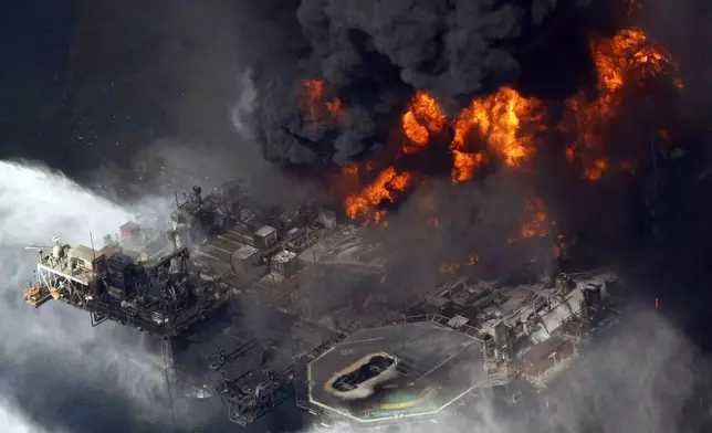 FILE - A plume of smoke rises from fires on BP's Deepwater Horizon offshore oil rig in the Gulf of Mexico on April 21, 2010. (AP Photo/Gerald Herbert, File)