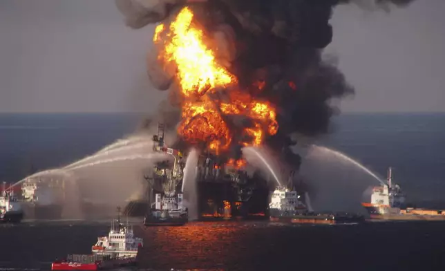 FILE - In this April 21, 2010 file photo provided by the U.S. Coast Guard, fire boat response crews spray water on the burning BP Deepwater Horizon offshore oil rig. (U.S. Coast Guard via AP, File)