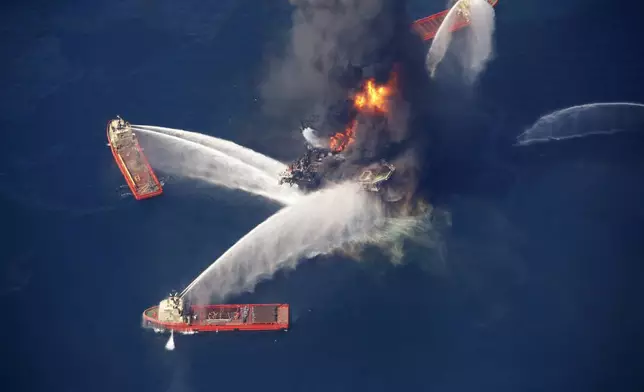 FILE - The Deepwater Horizon oil rig burns in the Gulf of Mexico on April 21, 2010, following an explosion that killed 11 workers and caused the worst offshore oil spill in the nation's history. (AP Photo/Gerald Herbert, File)