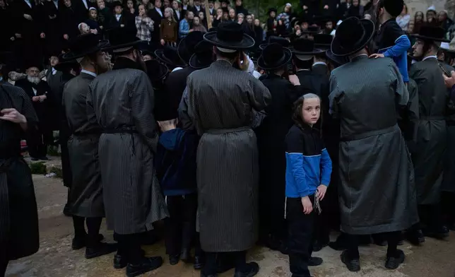 Ultra-Orthodox Jewish men gather to collect water from a spring to make matzoh, a traditional handmade unleavened bread for the holiday of Passover, during the Maim Shelanu ceremony at a mountain spring in the outskirts of Jerusalem, Thursday, April 10, 2025. (AP Photo/Ohad Zwigenberg)