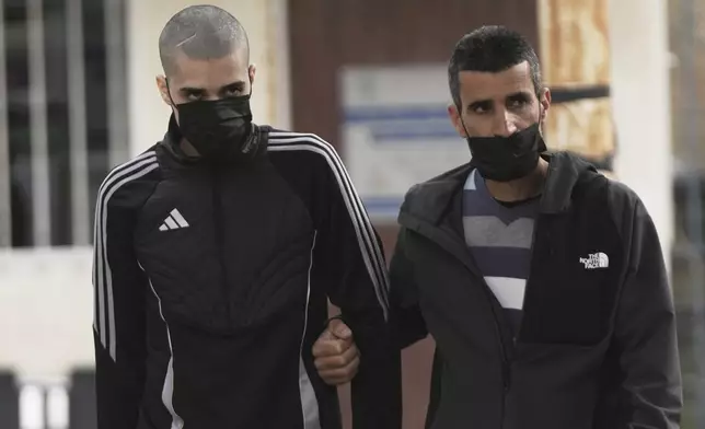 Palestinian Ahmed Manasra, left, who took part in an attack in 2015 when he was 13 and developed schizophrenia in prison, walks upon his release in Jerusalem, Thursday, April 10, 2025. (AP Photo/Mahmoud Illean)
