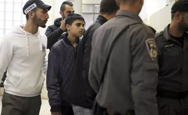 FILE - Ahmed Manasra, a 13-year-old Palestinian is brought to a court in Jerusalem, Tuesday Nov. 10, 2015. According to the indictment, Manasra and his cousin Hassan, 15, stabbed two Israelis in an east Jerusalem neighborhood. (AP Photo/Mahmoud Illean, File)