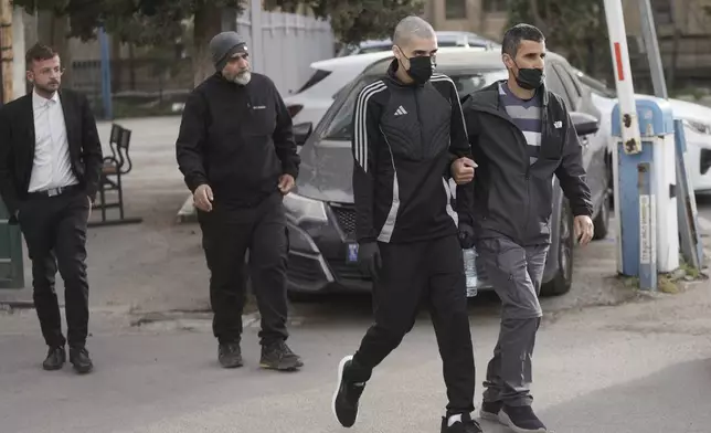 Palestinian Ahmed Manasra, second right, who took part in an attack in 2015 when he was 13 and developed schizophrenia in prison, walks upon his release in Jerusalem, Thursday, April 10, 2025. (AP Photo/Mahmoud Illean)