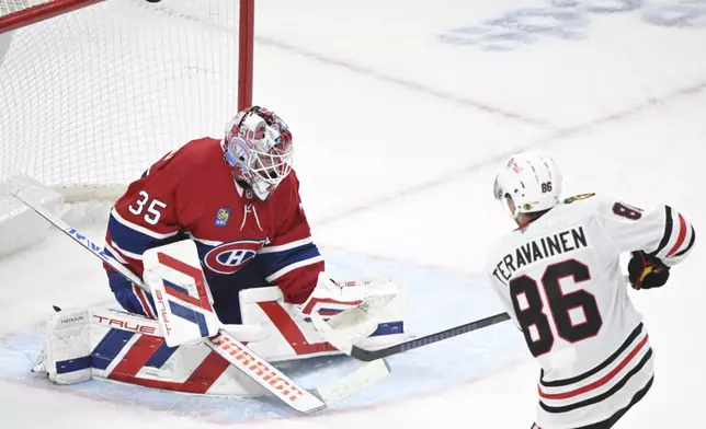 Montreal Canadiens goaltender Sam Montembeault, left, looks on as Chicago Blackhawks' Teuvo Teravainen (86) hits the bar with the puck during second-period NHL hockey game action in Montreal, Monday, April 14, 2025. (Graham Hughes/The Canadian Press via AP)