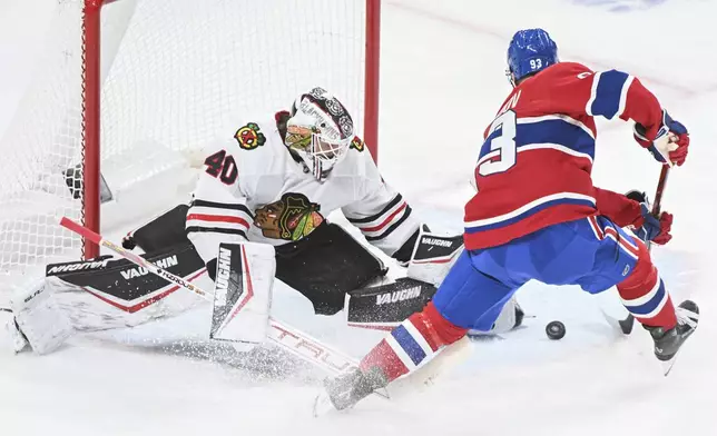 Montreal Canadiens' Ivan Demidov (93) moves in to score against Chicago Blackhawks goaltender Arvid Soderblom (40) during first-period NHL hockey game action in Montreal, Monday, April 14, 2025. (Graham Hughes/The Canadian Press via AP)