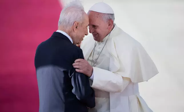 FILE - Pope Francis, right, talks with Israeli President Shimon Peres, during an official arrival ceremony at Ben Gurion airport near Tel Aviv, Israel, Sunday, May 25, 2014. (AP Photo/Oded Balilty, File)