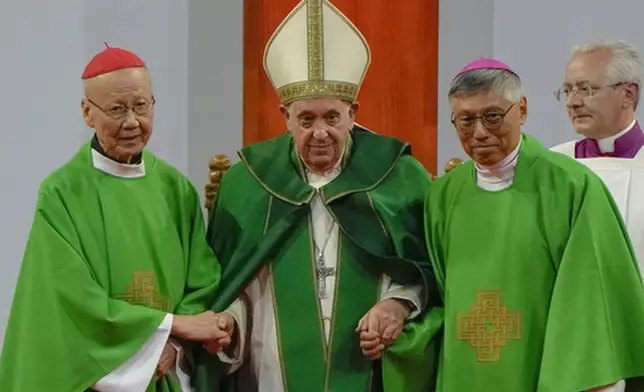 FILE - Pope Francis is joined by Cardinal John Tong Hon, left, and Cardinal-elect Stephen Chow, both from Hong Kong, after presiding over a mass at the Steppe Arena in the Mongolian capital Ulaanbaatar, Sunday, Sept. 3, 2023. (AP Photo/Ng Han Guan, File)