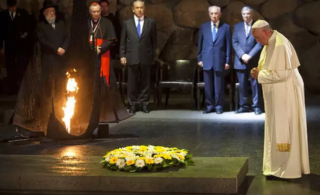 FILE - Pope Francis lays a wreath as Israel's President Shimon Peres and Israeli Prime Minister Benjamin Netanyahu stand at the Hall of Remembrance at the Yad Vashem Holocaust memorial in Jerusalem, Israel, Monday, May 26, 2014. (AP Photo/Dan Balilty, file)