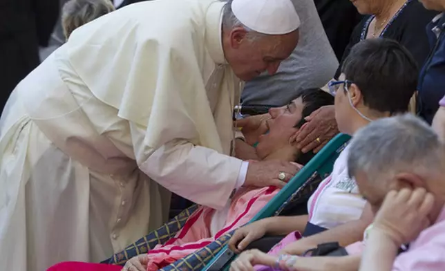 FILE - Pope Francis blesses sick and disabled people at the end of a pro-life Mass in St. Peter's Square, at the Vatican, Sunday, June 16, 2013. (AP Photo/Andrew Medichini, file)