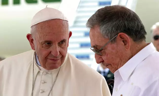 FILE - Pope Francis, left, looks at Cuba's President Raul Castro during his farewell ceremony at the airport in Santiago, Cuba, Tuesday, Sept. 22, 2015. (AP Photo/Enric Marti, file)