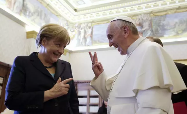 FILE - Pope Francis shares a light moment with German Chancellor Angela Merkel during their private audience at the Vatican, Saturday, May 18, 2013. (AP Photo/Gregorio Borgia, Pool, file)