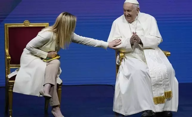FILE - Pope Francis and Giorgia Meloni attend a conference on birth rate, at Auditorium della Conciliazione, in Rome, Friday, May 12, 2023. (AP Photo/Alessandra Tarantino, File)