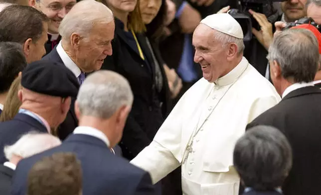 FILE - United States Vice President Joe Biden, left, shakes hands with Pope Francis during a congress on the progress of regenerative medicine held at the Vatican, Friday, April 29, 2016. (AP Photo/Andrew Medichini, File)