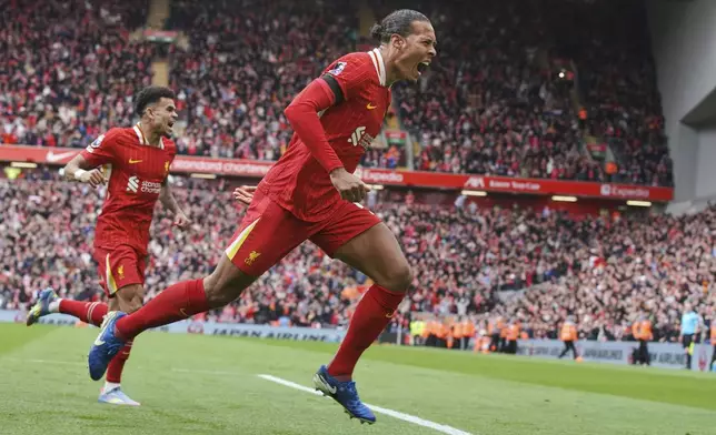 Liverpool's Virgil van Dijk celebrates after scoring his side's second goal during the English Premier League soccer match between Liverpool and West Ham United at Anfield in Liverpool, Sunday, April 13, 2025. (AP Photo/Ian Hodgson)