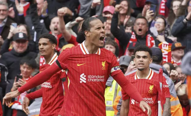 Liverpool's Virgil van Dijk celebrates after scoring his side's second goal during the English Premier League soccer match between Liverpool and West Ham United at Anfield in Liverpool, Sunday, April 13, 2025. (AP Photo/Ian Hodgson)